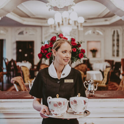 Ornate tea sets and regal decor located in the Drawing Room at the Prince of Wales Hotel