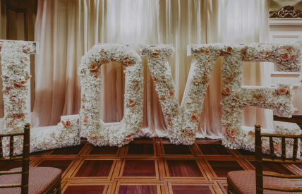 Large floral love sign in Victoria & Albert Ballroom wedding venue at the Prince of Wales Hotel in Niagara-on-the-Lake