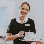 Staff member at Vintage Hotels serving afternoon tea