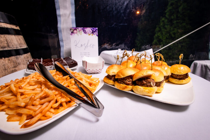 Sliders and fries served at a specialty table during a wedding.