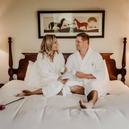 couple in bed in the main mill guestroom at millcroft inn and spa