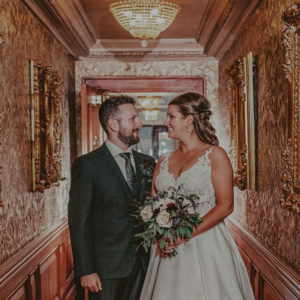 Bride and groom together in a Prince of Wales hallway
