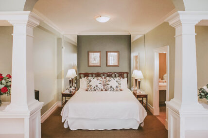 Lush king size bed in Signature Guest Suite at Inn On The Twenty in Jordan Village
