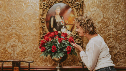 Woman enjoying floral ambience at the Prince of Wales Hotel in Niagara-on-the-Lake
