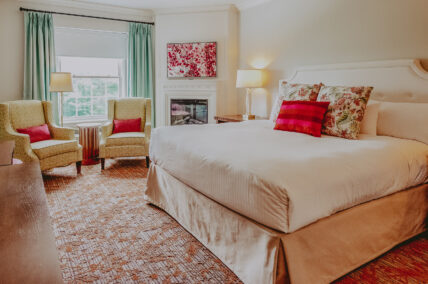Deluxe guest room with large windows and seating area at the Queens Landing Hotel in Niagara-on-the-Lake