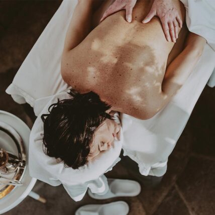 Woman receiving a massage during her stay at Pillar and Post, a luxury resort spa in Niagara on the Lake