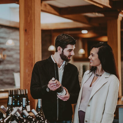 couple browsing wine at cave spring cellars