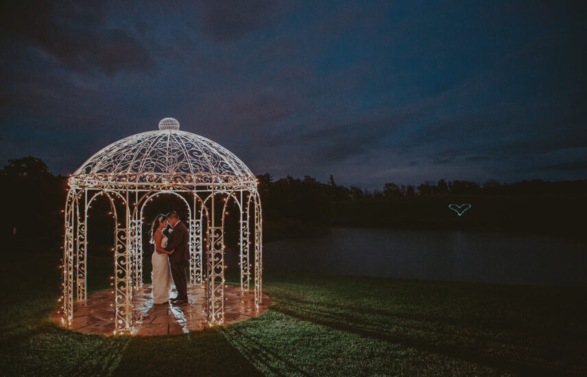 Bride and groom at night in the gazebo at Sue-Ann Staff Estate Winery near Inn On The Twenty in Jordan Station