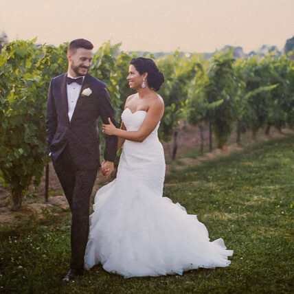 newly married couple walking in the vineyard at sue ann staff estate winery