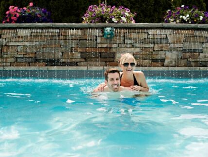 Couple enjoy a pool experience at Pillar and post