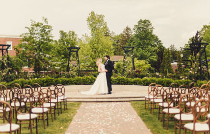 La Roserie wedding venue aisle view with bride and groom at Pillar & Post Hotel in Niagara-on-the-Lake