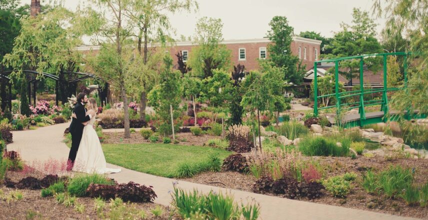Newlyweds share a private moment in the gardens of the Pillar & Post Hotel in Niagara-on-the-Lake
