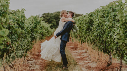 Newlyweds kissing at Sue-Ann Staff Estate Winery in Niagara-on-the-Lake
