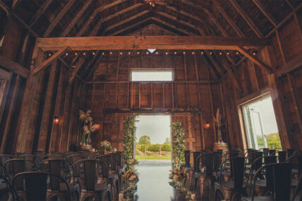 Indoor Barn Wedding Reception with doors open at Cave Spring Vineyard Jordan Ontario