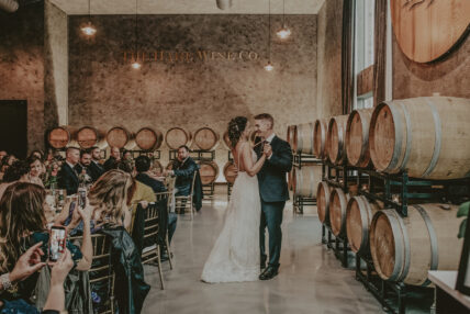 newly married couple dancing in the barrel room at the hare wine co in niagara on the lake