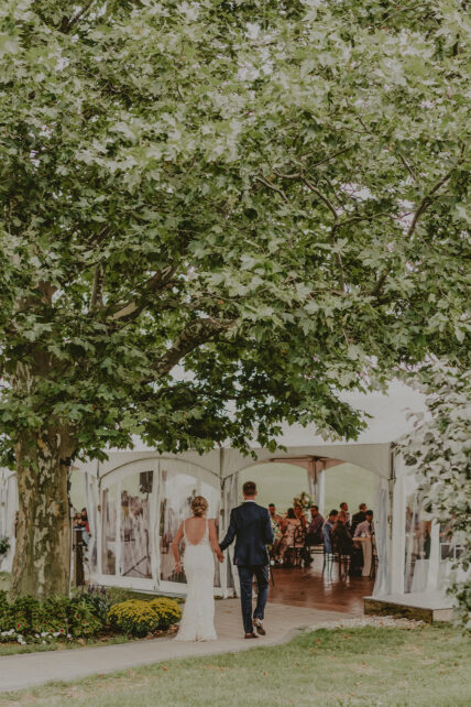 Newly married couple walks into the wedding tent at Sue Ann Staff Estate Winery