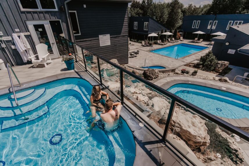 A couple unwinding in Millcroft Inn & Spa’s hot spring pools in Caledon.