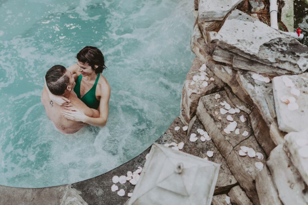 A couple in the hot spring pool at 100 Fountain Spa at Pillar and Post