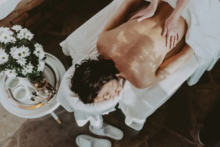 A woman receiving a massage during a spa getaway at a Vintage Hotels spa