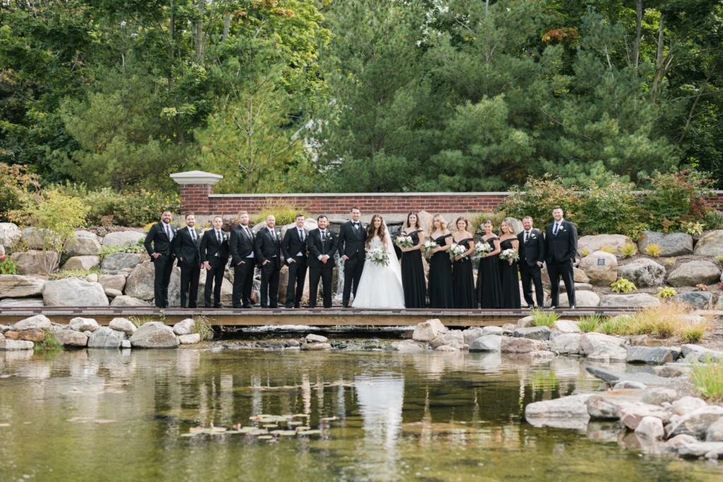 Wedding party overlooking the pond at The Gardens