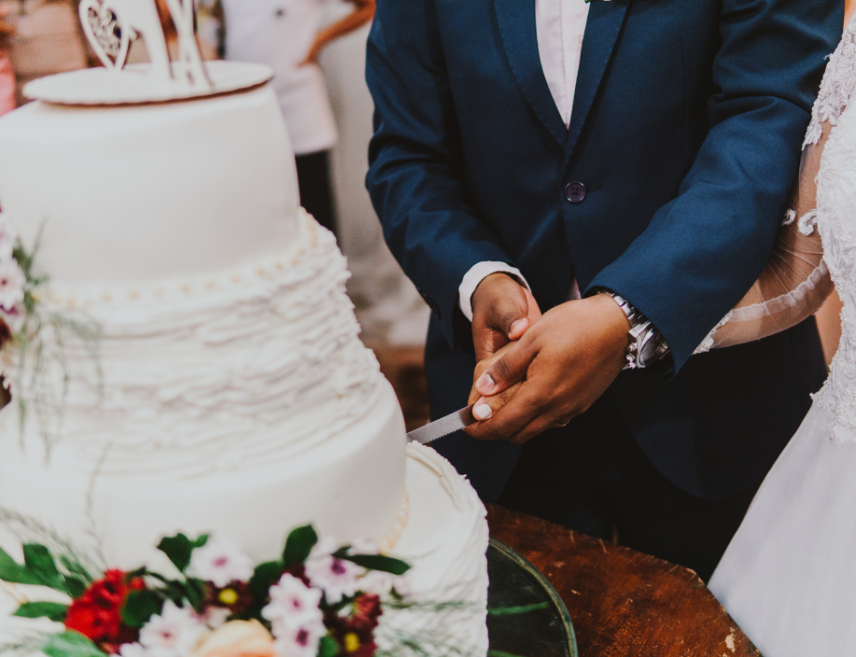 Newlyweds cutting their wedding cake