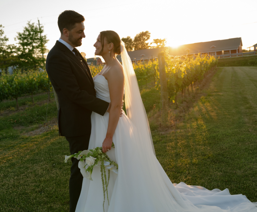 Wedding couple taking photos in the vineyards at The Hare Wine Co in Niagara-on-the-Lake.