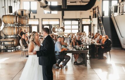 A couples first dance inside Queenston Mile Vineyard's Tasting Room