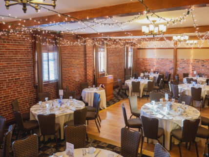 A cozy wedding venue with brick walls and warm lighting.