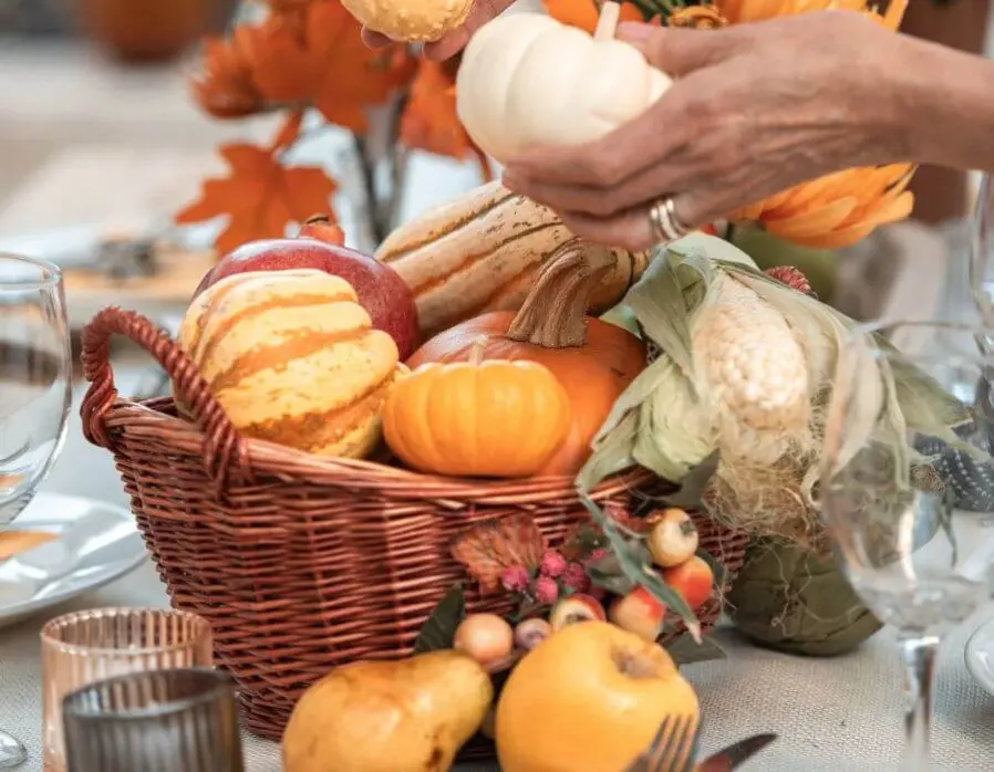 A fall basket filled with pumpkins.