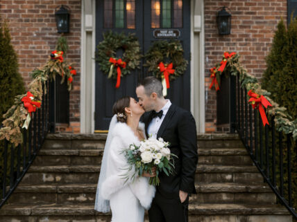 A couple surrounded by Christmas decorations at Pillar and Post in Niagara on the Lake
