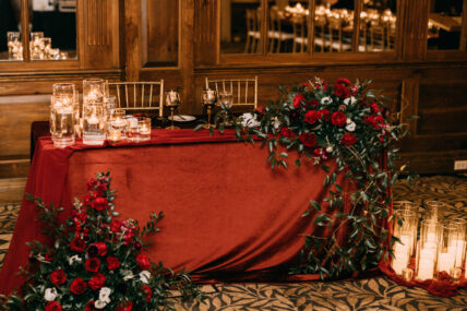 A Christmas wedding table at Pillar and Post decorated with candles and greenery