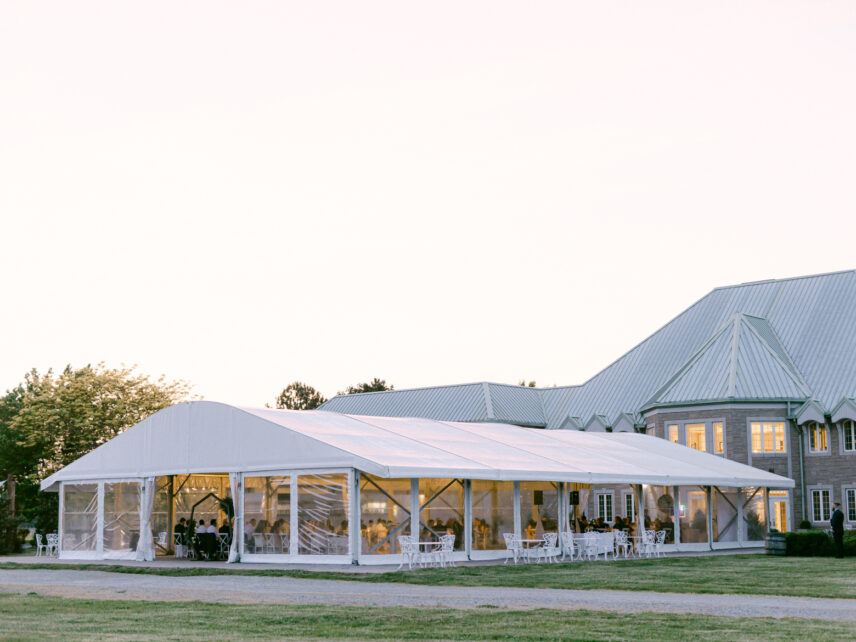 A wedding reception hosted in a tent outside of Château des Charmes.