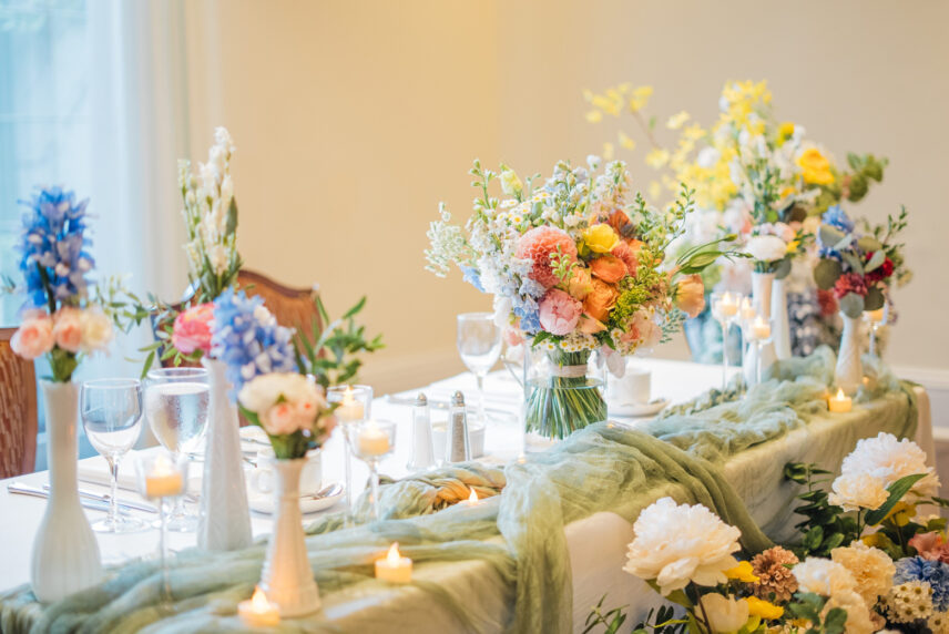 Florals placed throughout a wedding table setting at Queen’s Landing.