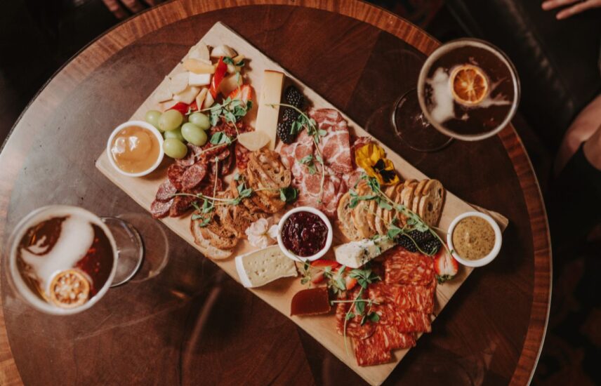 Couple dining on a charcuterie board at Churchill Lounge at the Prince of Wales Hotel in Niagara-on-the-Lake