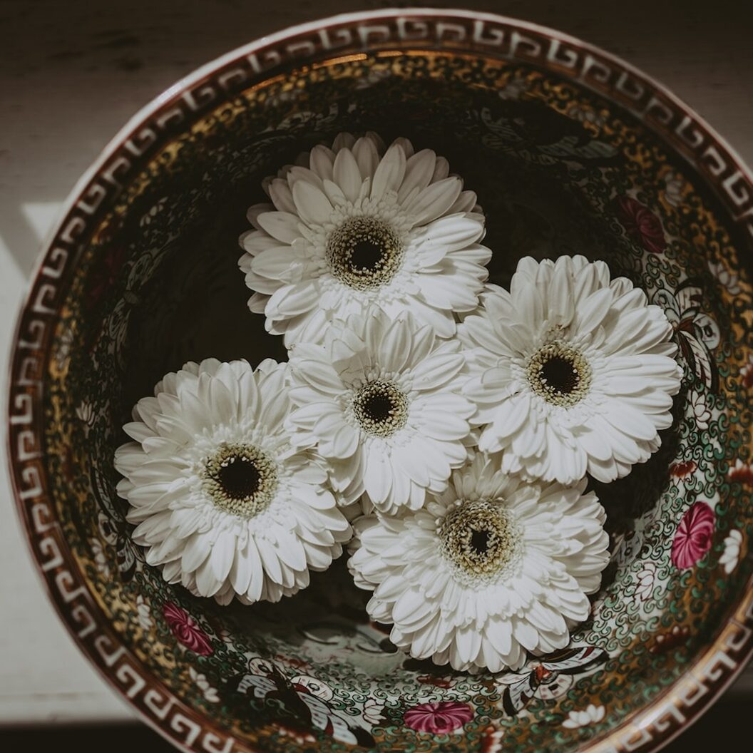 White flowers laid in a bowl for an east Indian wedding at Queen's Landing Hotel in Niagara-on-the-Lake.