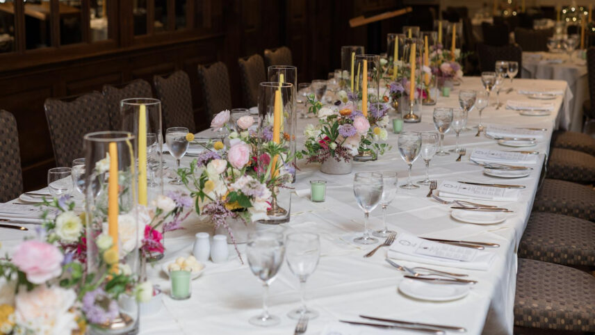 Wedding menus scattered across a guest table at Pillar and Post.