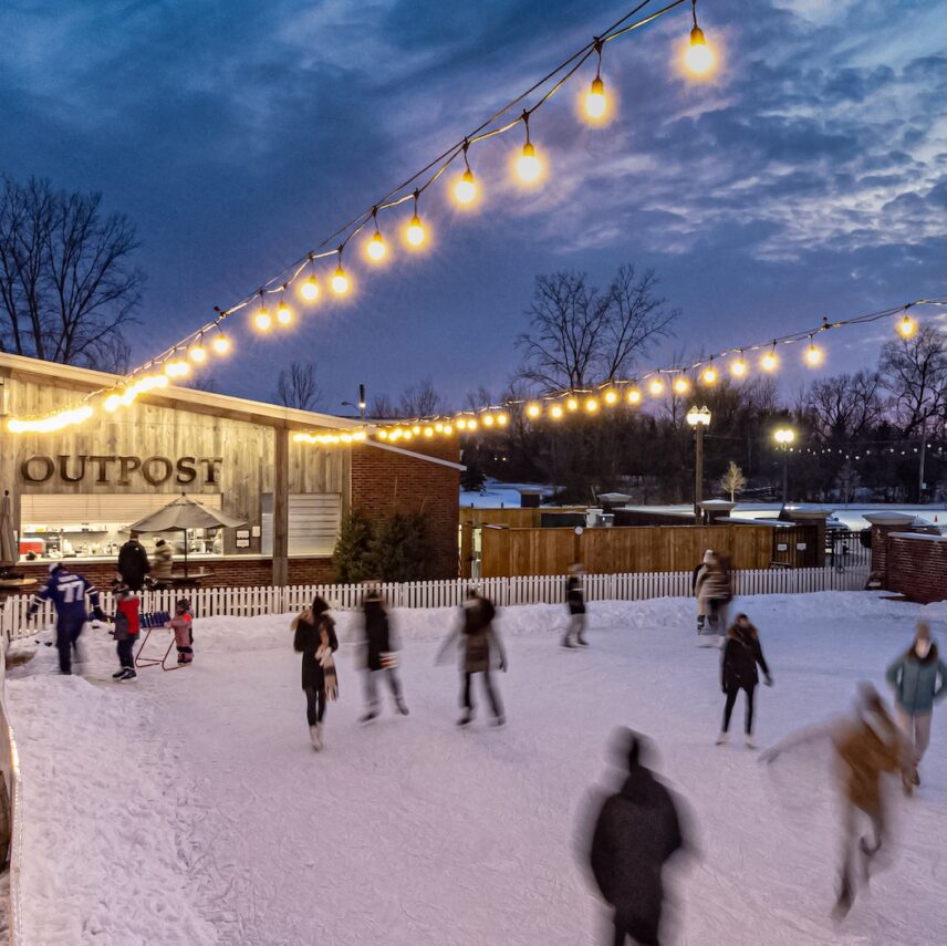 People skating at night on the outdoor winter rink in The Gardens at Pillar and Post in Niagara-on-the-Lake