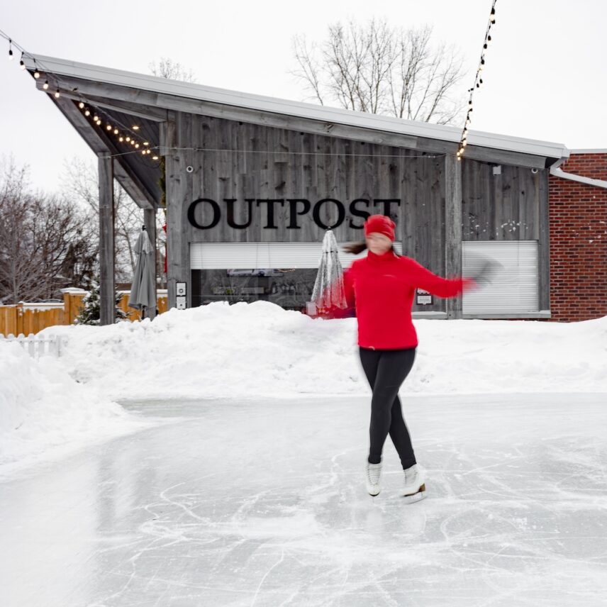 A young women skating at the outdoor winter rink in The Gardens at Pillar and Post in Niagara-on-the-Lake