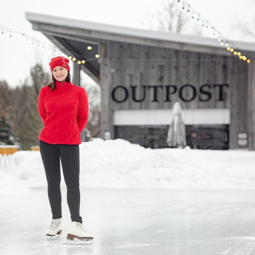 A young women skating at the outdoor winter rink in The Gardens at Pillar and Post in Niagara-on-the-Lake