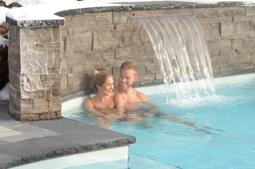Couple relaxing in outdoor hot spring pools at Millcroft Inn & Spa in Caledon, Ontario