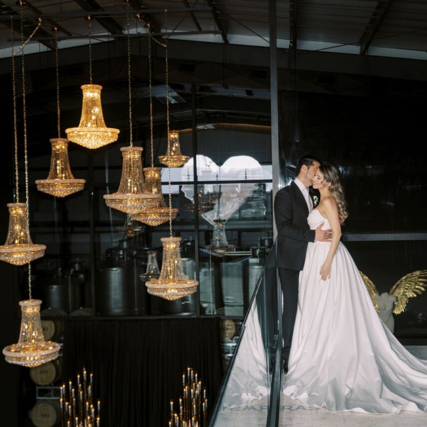 A newly married couple poses for photos at Amo Estate Winery a wedding venue in Niagara on the Lake