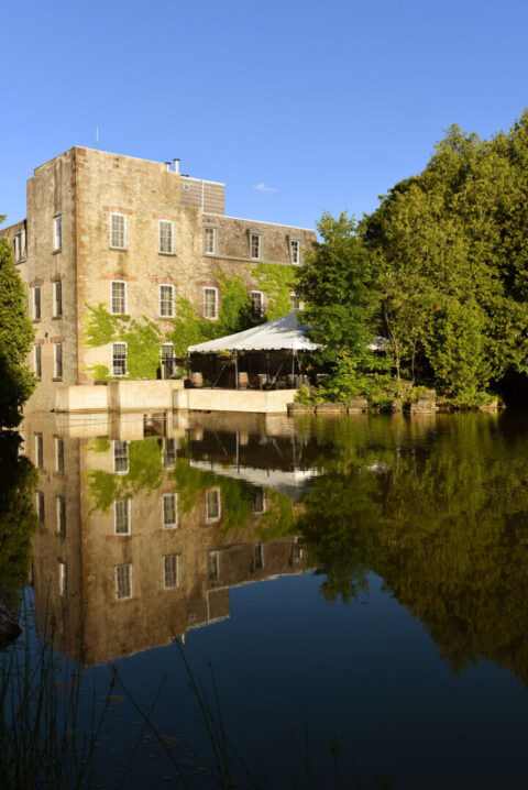Restored exterior of Millcroft Inn & Spa surrounded by rolling Caledon countryside and millpond views