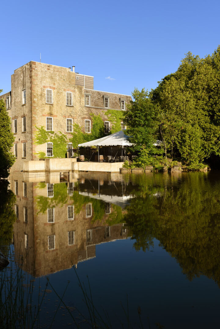Restored exterior of Millcroft Inn & Spa surrounded by rolling Caledon countryside and millpond views