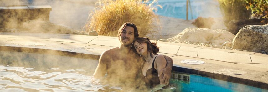 A couple relaxing in outdoor hot spring pools at Millcroft and Spa, near Caledon.