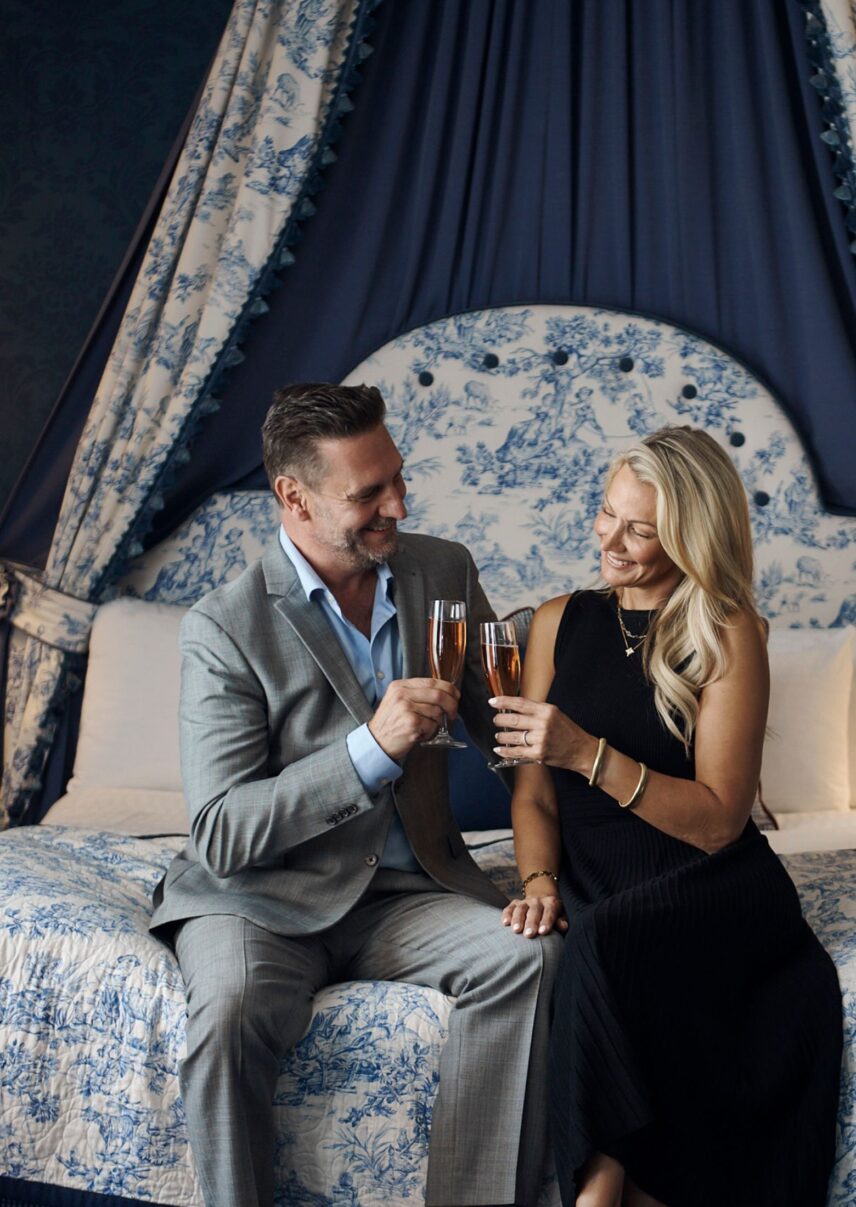 Couple enjoying some bubbly in their Blue Room Suite at the Prince of Wales Hotel in the heart of Niagara-on-the-Lake.
