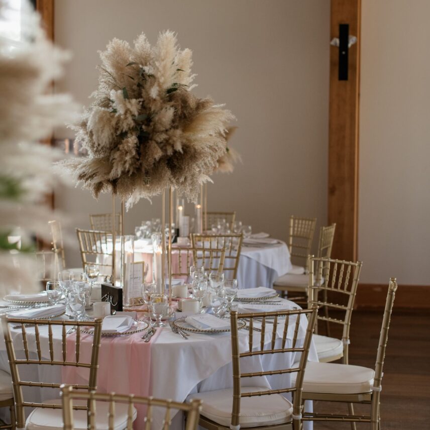 tall feather centrepiece at The Barn at Pillar and Post wedding reception