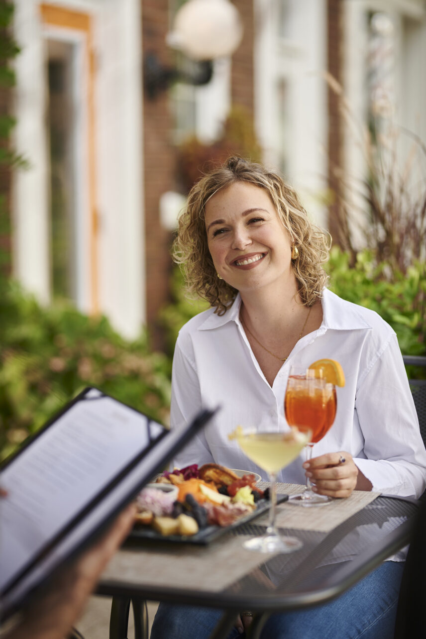 Guest enjoying local wine and farm-to-table dining at Inn On The Twenty in Jordan Village