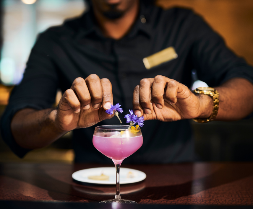 Bartender garnishing cocktail in Bacchus Lounge within Queen's Landing hotel in Niagara-on-the-Lake